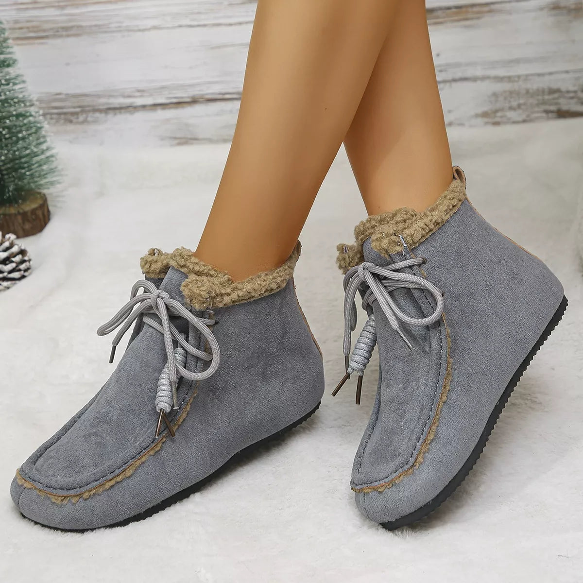 Women’s suede lace-up flat ankle boots with cozy fluffy trim in gray.