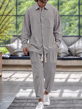 Men’s gray button down long sleeve shirt and matching pants two-piece set with drawstring waist, available in sizes Small–2XL.