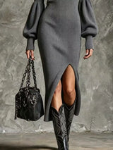Woman wearing a gray ribbed knit quarter-zip sweater dress with long lantern sleeves, front slit and black embroidered western boots.