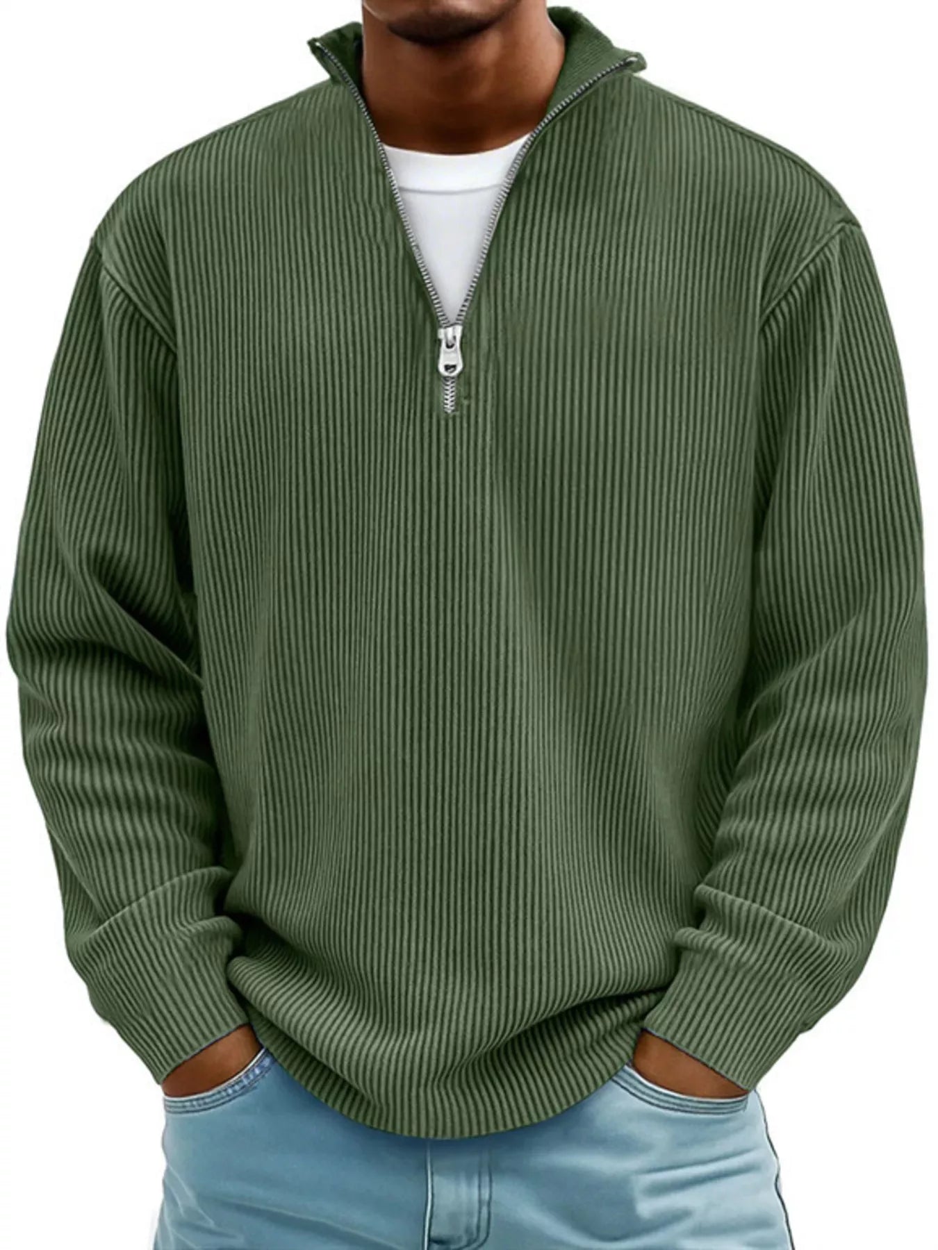 Man wearing a green ribbed corduroy quarter zip pullover sweatshirt layered over a white shirt.
