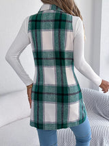 Women’s green plaid double-breasted long vest coat with pockets styled over a white turtleneck and jeans.