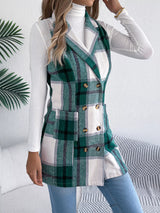 Women’s green plaid double-breasted long vest coat with pockets styled over a white turtleneck and jeans.