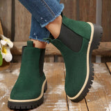 Green suede round toe Chelsea ankle boots with black elastic side panels, mid-block heels and lug soles.