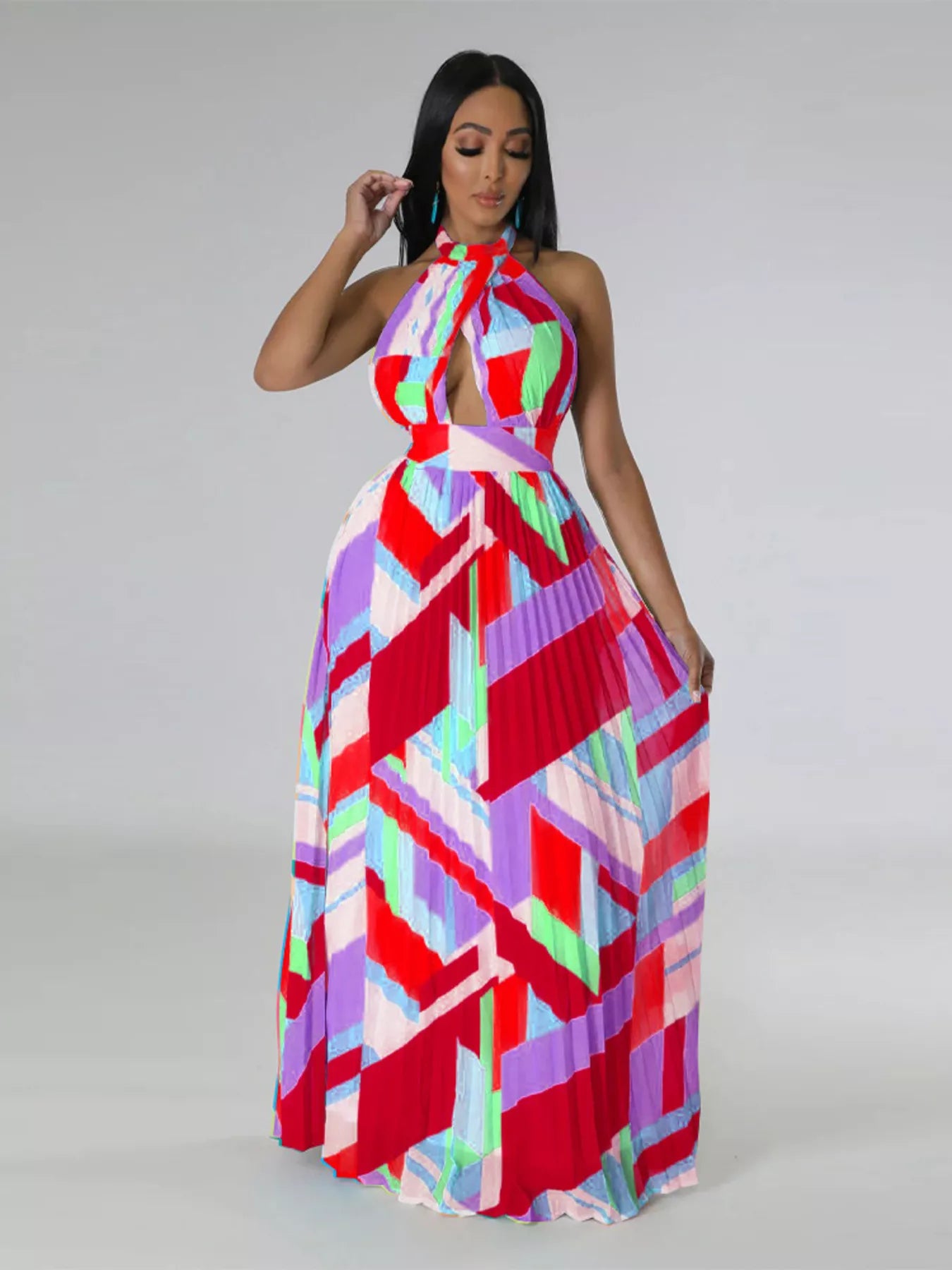 Woman wearing a colorful red geometric patterned dress on a gray background