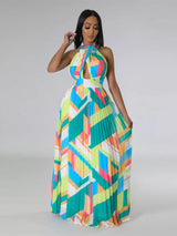 Woman wearing a colorful green geometric patterned dress on a gray background
