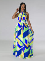 Woman wearing a colorful blue geometric patterned dress on a gray 
background
