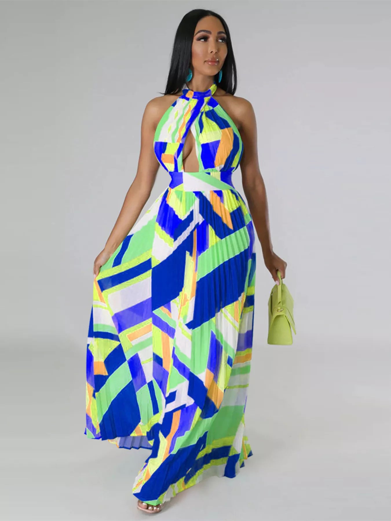 Woman wearing a colorful blue geometric patterned dress on a gray background