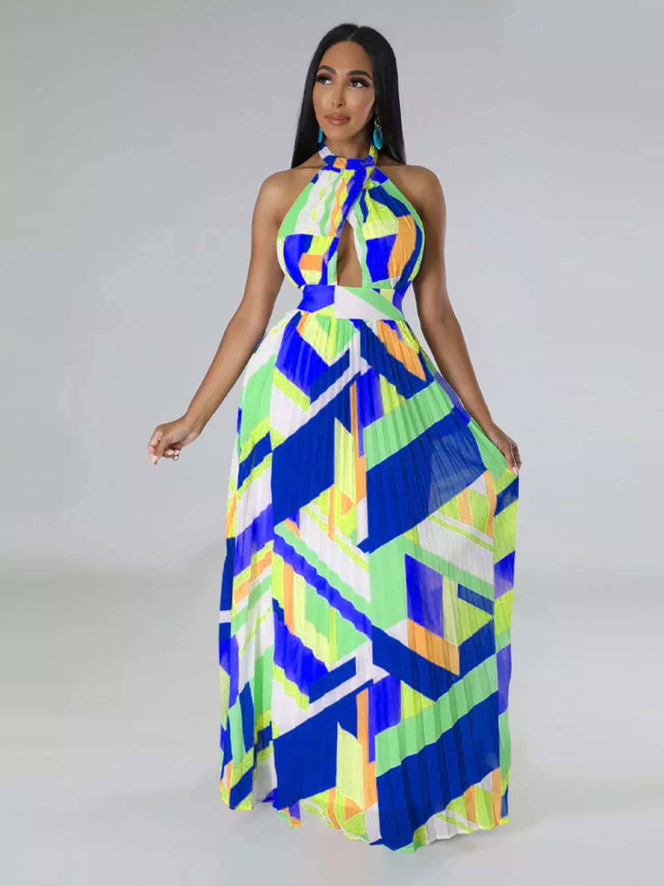 Woman wearing a colorful blue geometric patterned dress on a gray background