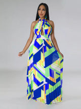 Woman wearing a colorful blue geometric patterned dress on a gray background