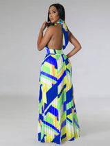 Woman wearing a colorful blue geometric patterned dress on a white background