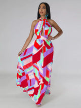 Woman wearing a colorful red geometric patterned dress on a plain background