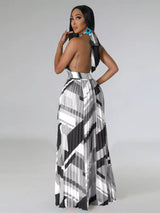 Woman wearing a black and white geometric patterned dress on a gray background