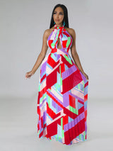 Woman wearing a colorful red geometric patterned dress on a gray background