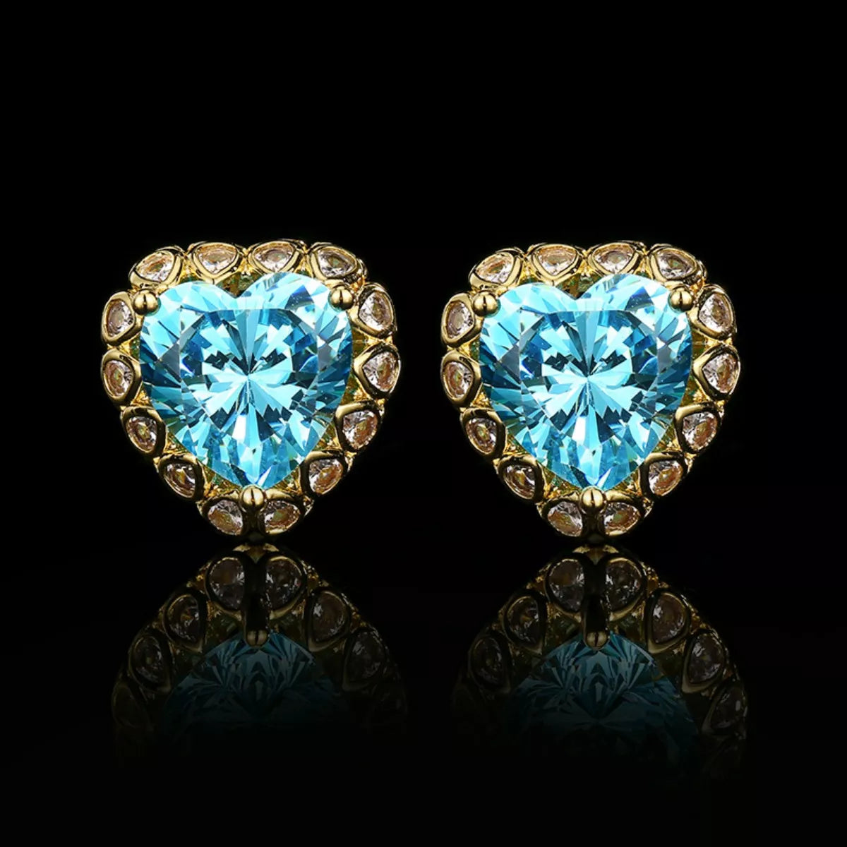 Heart-shaped aquamarine stud earrings with sparkling zircon halo accents in an elegant 18K gold-plated setting.