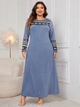 Woman wearing the Honey Plus Size Printed Long Sleeve Maxi Dress in blue with a Nordic-inspired print across the neckline and sleeves, cozy plus size fall maxi dress from Chic Mystik Boutique.