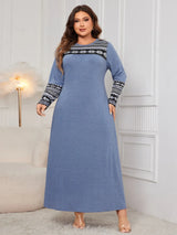 Woman wearing the Honey Plus Size Printed Long Sleeve Maxi Dress in blue with a Nordic-inspired print across the neckline and sleeves, cozy plus size fall maxi dress from Chic Mystik Boutique.