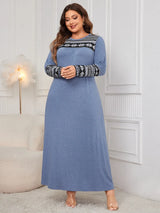 Woman wearing the Honey Plus Size Printed Long Sleeve Maxi Dress in blue with a Nordic-inspired print across the neckline and sleeves, cozy plus size fall maxi dress from Chic Mystik Boutique.