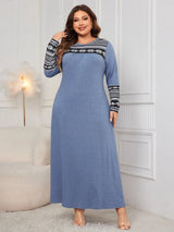 Woman wearing the Honey Plus Size Printed Long Sleeve Maxi Dress in blue with a Nordic-inspired print across the neckline and sleeves, cozy plus size fall maxi dress from Chic Mystik Boutique.