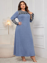 Woman wearing the Honey Plus Size Printed Long Sleeve Maxi Dress in blue with a Nordic-inspired print across the neckline and sleeves, cozy plus size fall maxi dress from Chic Mystik Boutique.