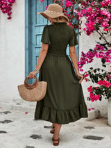 Back view of women's olive-green midi skirt with elastic waistband and wide ruffled hem.