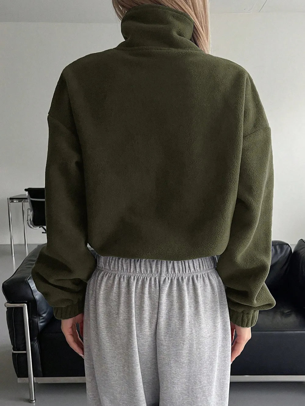 Woman wearing the Honey Zip Up Long Sleeve Cropped Jacket in olive green with joggers and a baseball cap, lightweight cropped fall jacket available at Chic Mystik Boutique.
