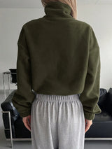 Woman wearing the Honey Zip Up Long Sleeve Cropped Jacket in olive green with joggers and a baseball cap, lightweight cropped fall jacket available at Chic Mystik Boutique.