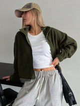 Woman wearing the Honey Zip Up Long Sleeve Cropped Jacket in olive green with joggers and a baseball cap, lightweight cropped fall jacket available at Chic Mystik Boutique.