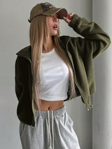 Woman wearing the Honey Zip Up Long Sleeve Cropped Jacket in olive green with joggers and a baseball cap, lightweight cropped fall jacket available at Chic Mystik Boutique.