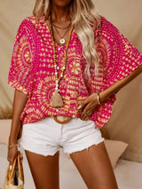Hot pink printed V-neck top with half sleeves and a relaxed boho-inspired fit paired with white shorts.