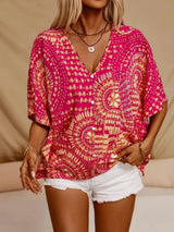 Hot pink printed V-neck top with half sleeves and a relaxed boho-inspired fit paired with white shorts.