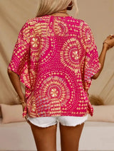 Hot pink printed V-neck top with half sleeves and a relaxed boho-inspired fit paired with white shorts.