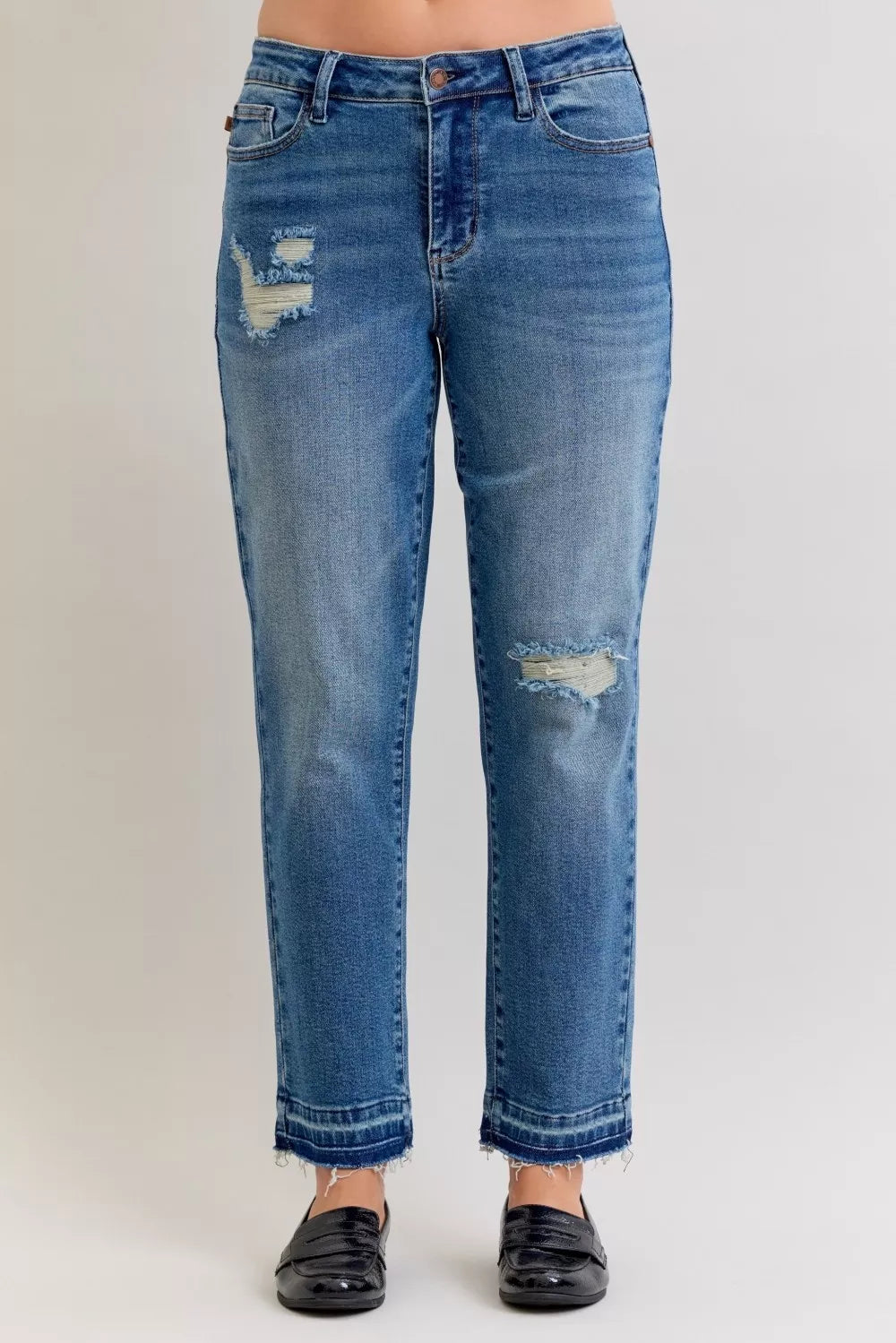 Judy Blue Full-Size Mid-Rise BF Patch & Repair Destroy Release Hem Jeans in medium wash featuring distressed detailing, boyfriend fit, raw release hem, and slightly stretchy denim for casual everyday style.