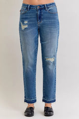 Judy Blue Full-Size Mid-Rise BF Patch & Repair Destroy Release Hem Jeans in medium wash featuring distressed detailing, boyfriend fit, raw release hem, and slightly stretchy denim for casual everyday style.