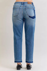 Judy Blue Full-Size Mid-Rise BF Patch & Repair Destroy Release Hem Jeans in medium wash featuring distressed detailing, boyfriend fit, raw release hem, and slightly stretchy denim for casual everyday style.