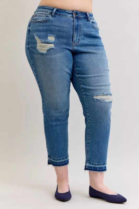 Judy Blue Full-Size Mid-Rise BF Patch & Repair Destroy Release Hem Jeans in medium wash featuring distressed detailing, boyfriend fit, raw release hem, and slightly stretchy denim for casual everyday style.