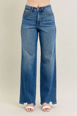 Judy Blue Full Size High Waist Tummy Control Chew Hem Destroy Wide Jeans in medium wash featuring a flattering high-rise fit, wide-leg silhouette, distressed details, raw chew hem, and slightly stretchy denim.  