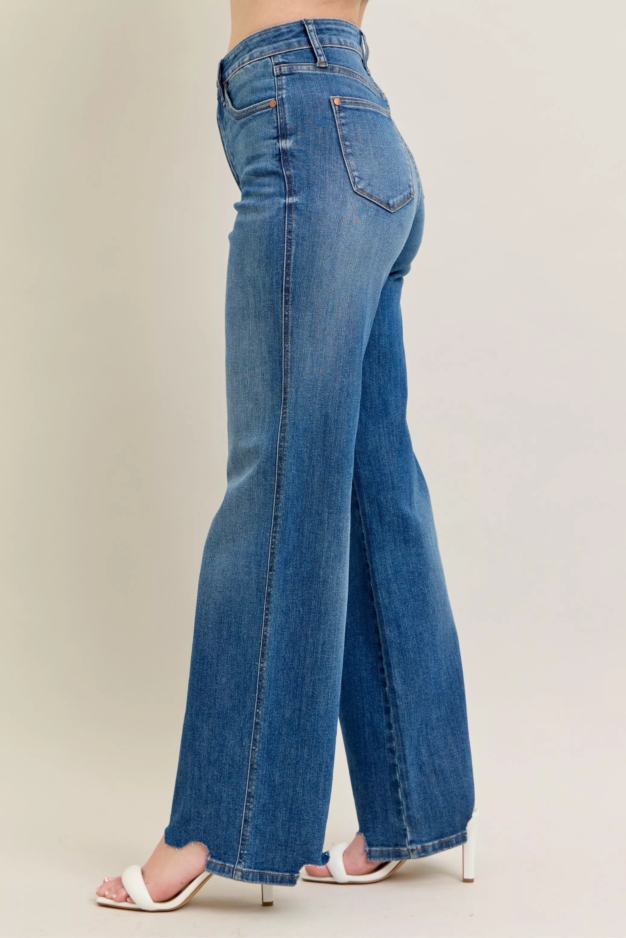 Judy Blue Full Size High Waist Tummy Control Chew Hem Destroy Wide Jeans in medium wash featuring a flattering high-rise fit, wide-leg silhouette, distressed details, raw chew hem, and slightly stretchy denim.