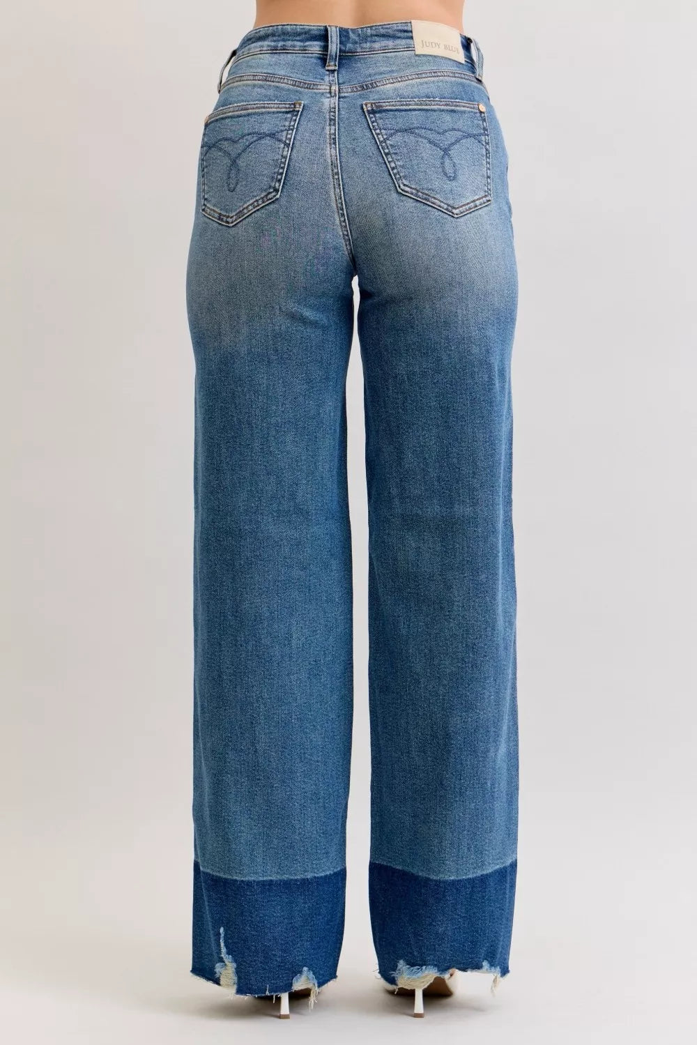 Judy Blue Raw Hem High Waist Column Straight Jeans in medium wash featuring a flattering high-rise fit, wide column straight-leg silhouette, raw hem detailing, and classic five-pocket styling for everyday wear.