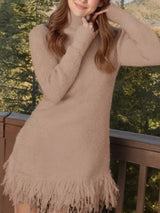 Woman wearing a khaki fringe turtleneck long sleeve sweater dress with brown knee-high boots, a cozy fall outfit from Chic Mystik Boutique.