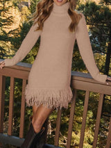 Woman wearing a khaki fringe turtleneck long sleeve sweater dress with brown knee-high boots, a cozy fall outfit from Chic Mystik Boutique.