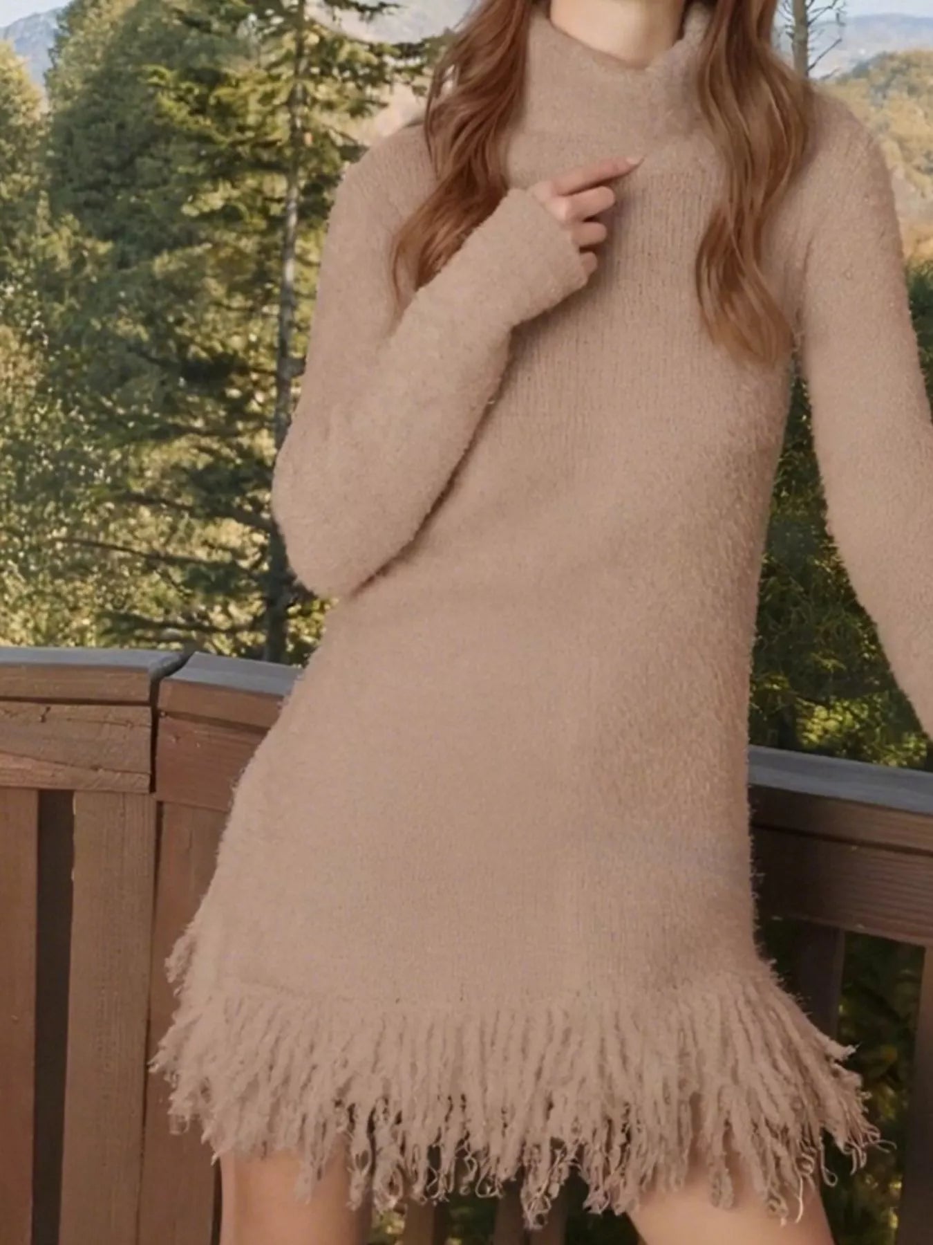 Woman wearing a khaki fringe turtleneck long sleeve sweater dress with brown knee-high boots, a cozy fall outfit from Chic Mystik Boutique.