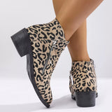 Woman wearing khaki leopard-print ankle boots with block heels and side zipper details.