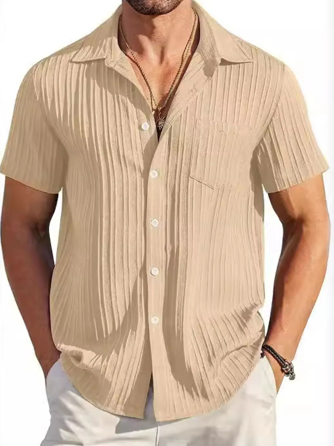 Man wearing a khaki textured short sleeve button-up shirt with white pants for a polished casual summer look.
