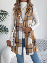Women’s khaki plaid double-breasted long vest coat with pockets styled over a white turtleneck and jeans.