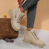 Women’s fleece-lined lace-up combat boots with chunky rubber sole and side detail, available in khaki, black and white.