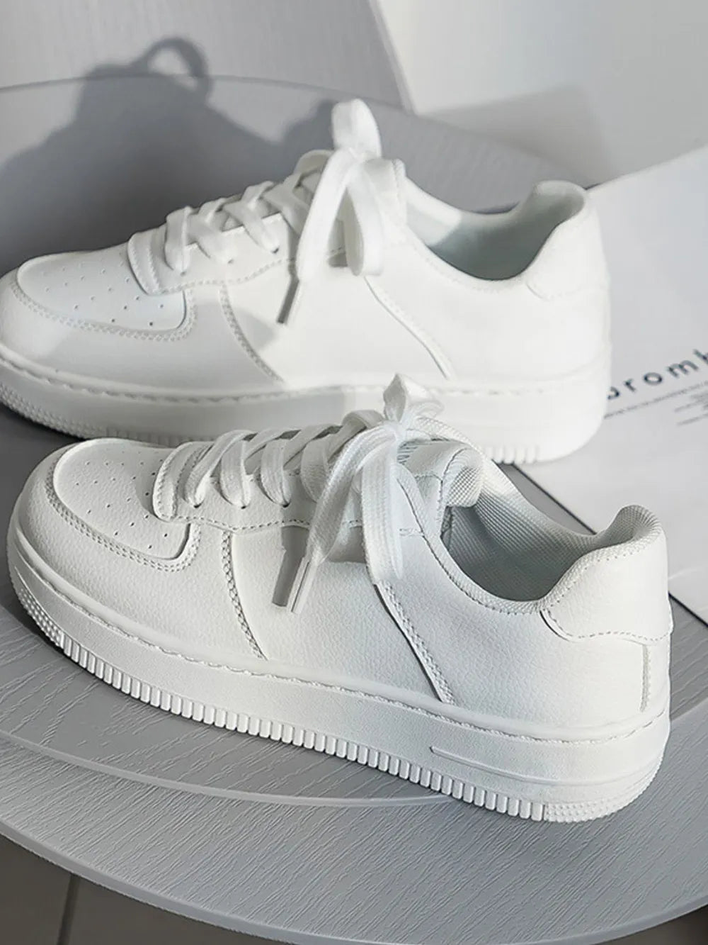 White sneakers on a light gray surface