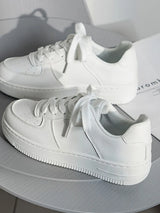White sneakers on a light gray surface