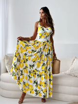 Woman wearing a yellow lemon print dress in a minimalistic room.