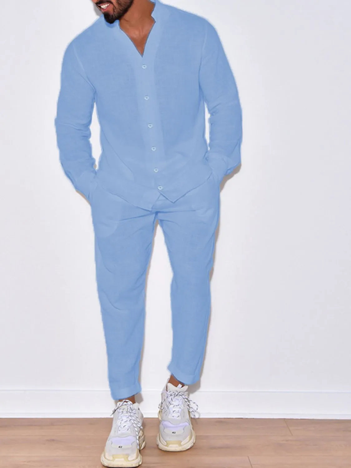 Men’s light blue button up long sleeve top and matching pants two-piece set styled with white sneakers, available in sizes Small–2XL.