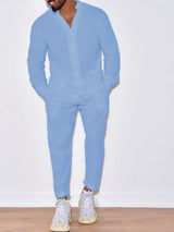 Men’s light blue button up long sleeve top and matching pants two-piece set styled with white sneakers, available in sizes Small–2XL.